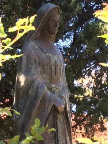 Bronze statue of Sister Henrietta Stockdale standing above her grave in the Garden of Remembrance at St Cyprian's Cathedral, Kimberley.