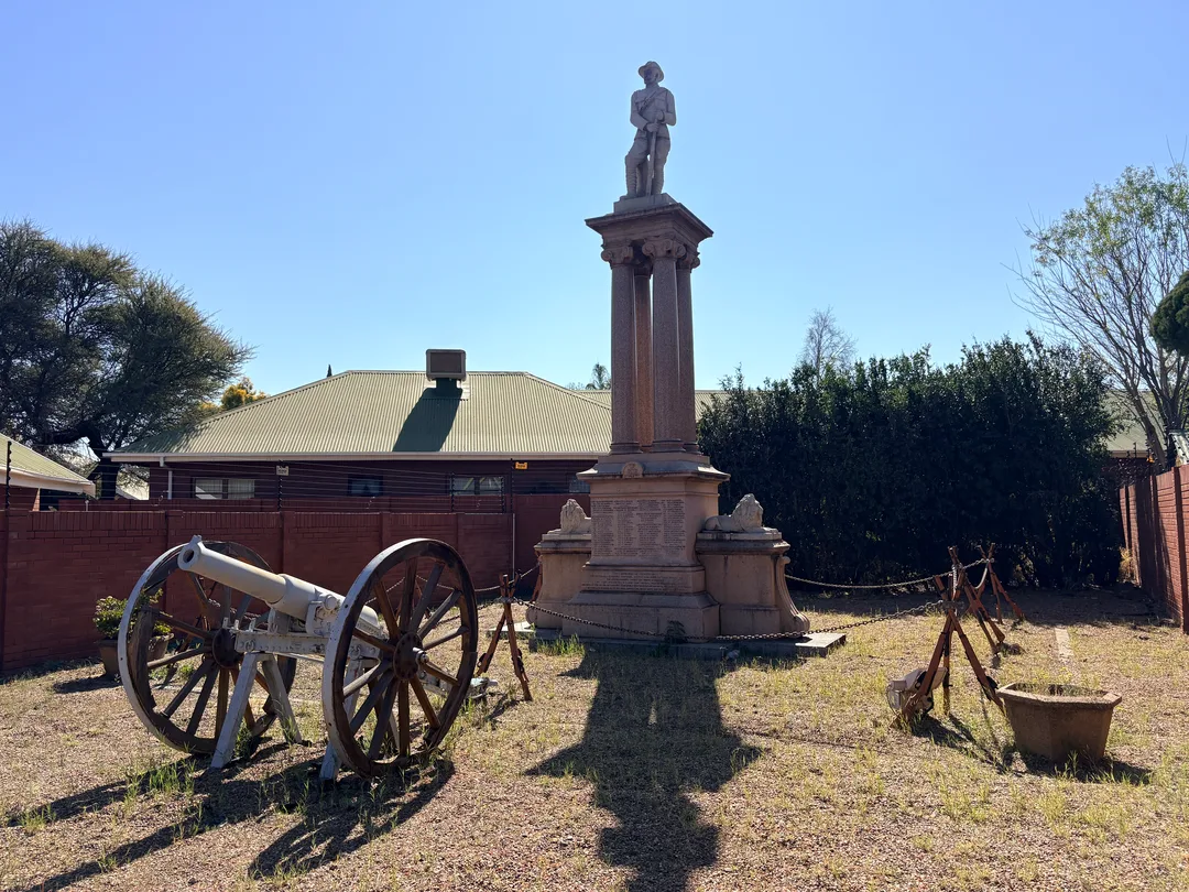 Viewed from the south, the memorial's life-sized granite policeman stands atop four polished red granite columns, symbolically watching over the battlefield at Carter's Ridge.