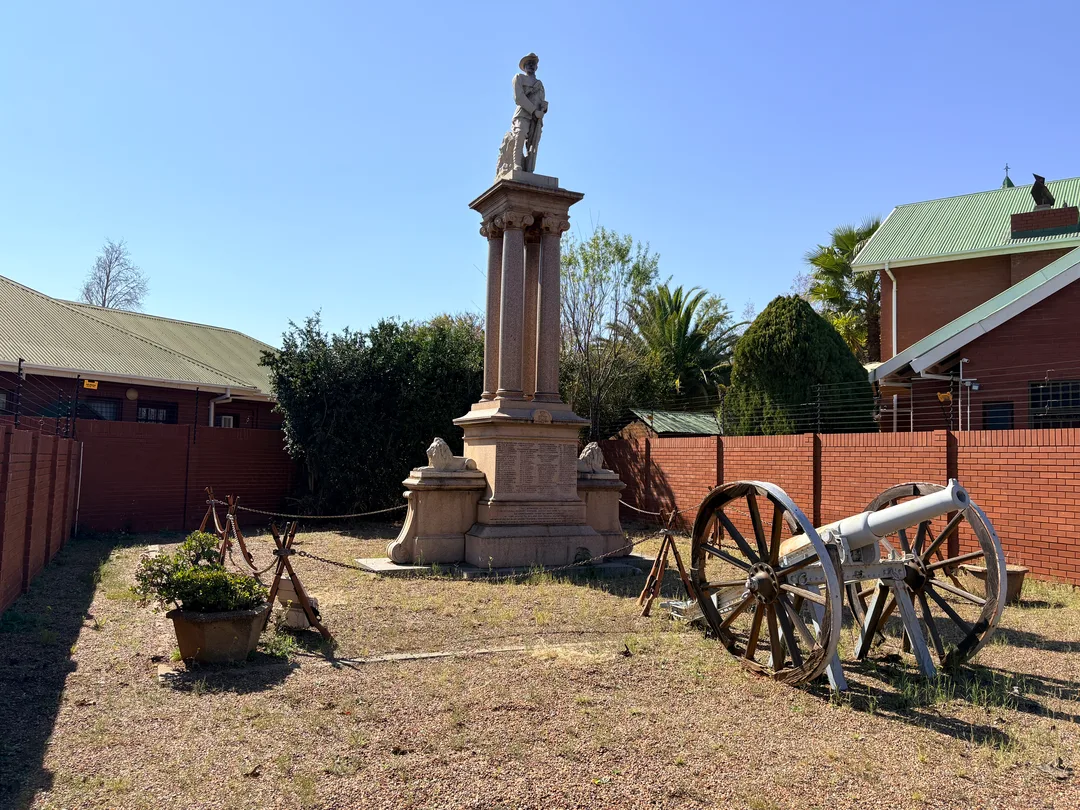 The Cape Police Memorial in its Belgravia setting. Unveiled in 1904, the granite monument faces Carter's Ridge, where several Cape Police officers lost their lives during the Siege of Kimberley.